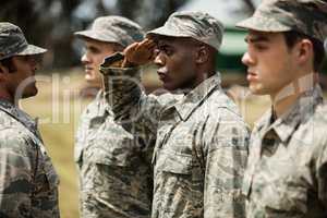 Military trainer giving training to military soldier