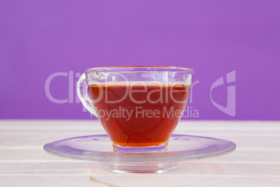 Cup of herbal tea on white table