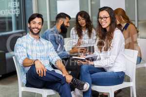 Portrait of male and female executives sitting in meeting