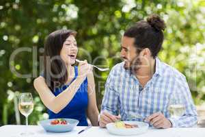 Woman feeding food to man
