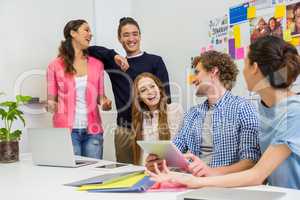 Smiling executives interacting during meeting in conference room