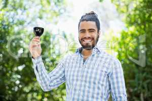 Man holding glass of wine in the park