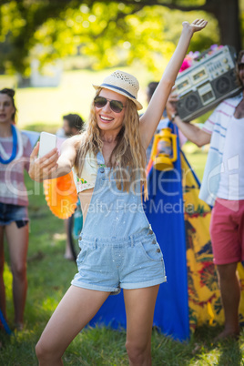 Woman taking selfie at campsite