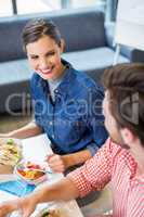 Happy executives interacting while having breakfast