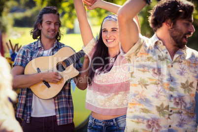 Group of friends having fun together at campsite