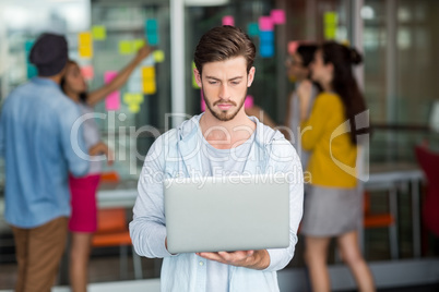 Attentive male executive using laptop