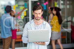 Attentive male executive using laptop