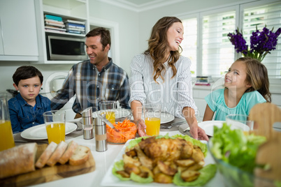 Smiling family having lunch together on dining table