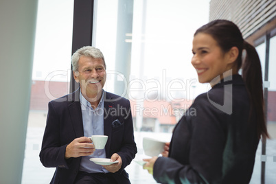 Happy businessman man and businesswoman having coffee