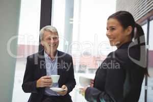 Happy businessman man and businesswoman having coffee