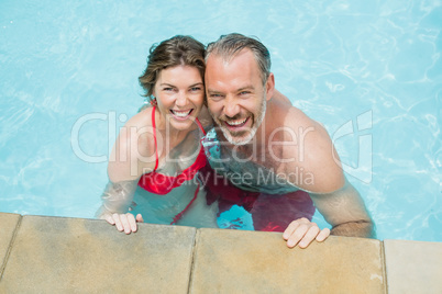 Portrait of happy couple in swimming pool