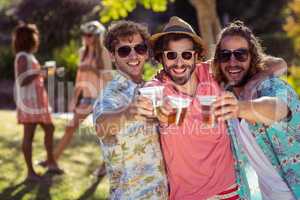 Three friends toasting glasses of beer