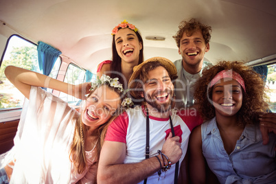 Group of friends having fun in campervan