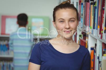 Portrait of smiling schoolgirl smiling in library