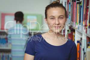 Portrait of smiling schoolgirl smiling in library