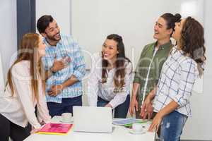 Smiling executives interacting during meeting in conference room