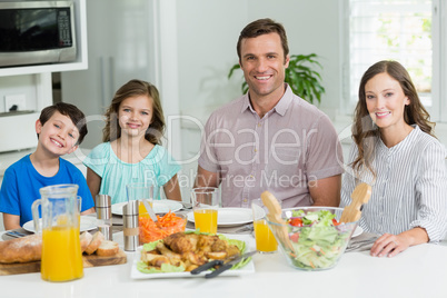 Portrait of smiling family having lunch together on dining table