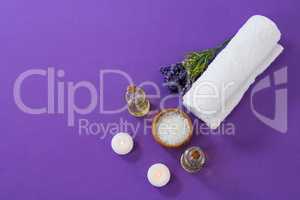 Spa accessories arranged on purple background