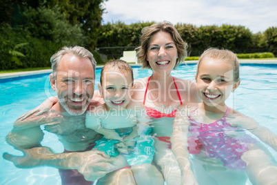 Happy parents and kids in pool