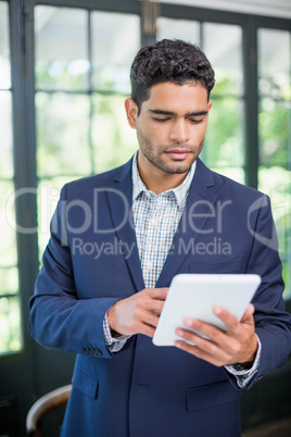 Portrait of businessman using digital tablet