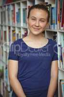 Portrait of smiling schoolgirl smiling in library