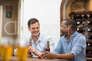 Friends having a conversation while having beer