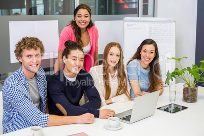 Portrait of smiling executives in conference room