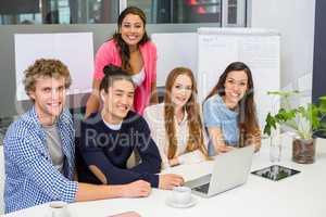 Portrait of smiling executives in conference room