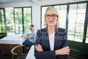 Businesswoman standing with arms crossed in a restaurant