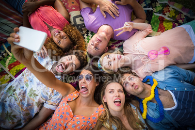 Group of friends lying in a circle and taking a selfie