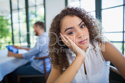 Upset woman sitting in a restaurant