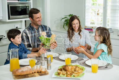 Smiling family having lunch together on dining table