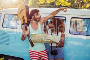 Couple looking at map near campervan