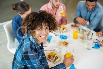 Portrait of happy male executive having breakfast