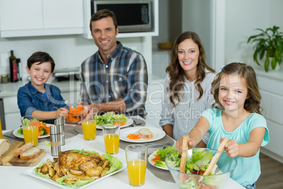 Portrait of smiling family having lunch together on dining table