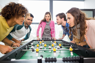 Executives playing table football