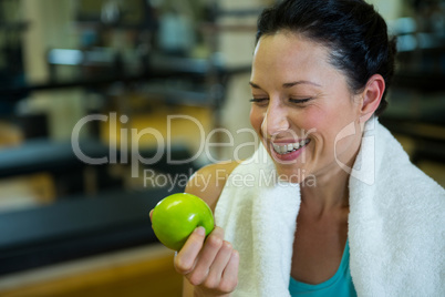 Fit woman holding green apple