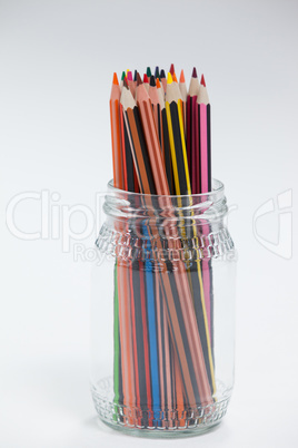 Colored pencils kept in a glass jar