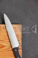 Knife on wooden board