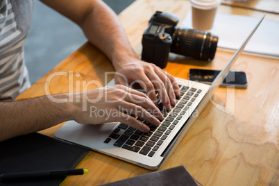 Graphic designer using laptop in creative office Graphic designer using laptop in creative office