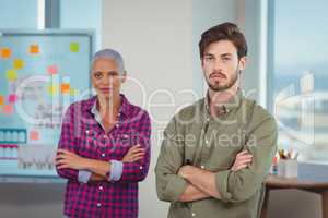 Portrait of business executives standing with arms crossed