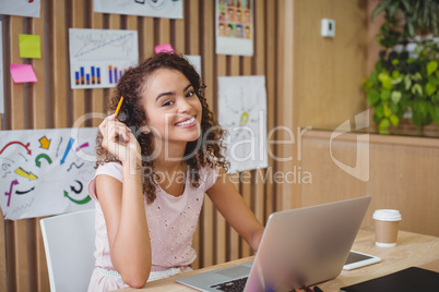 Portrait of female graphic designer using laptop