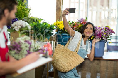 Woman taking a selfie at florist shop