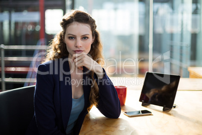 Business executive using digital tablet and mobile phone in office