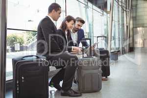 Business executives using laptop on platform