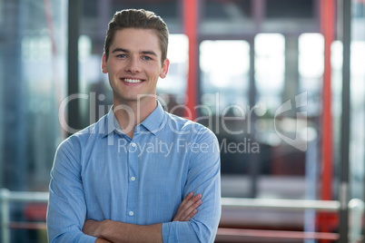 Business executive standing with arms crossed in office Business executive standing with arms crossed in office