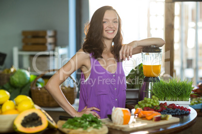 Smiling shop assistant standing at counter