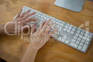 Hand of female graphic designer typing on keyboard