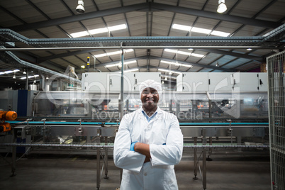 Portrait of factory engineer standing with his arms crossed