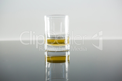 Glass of whisky on table